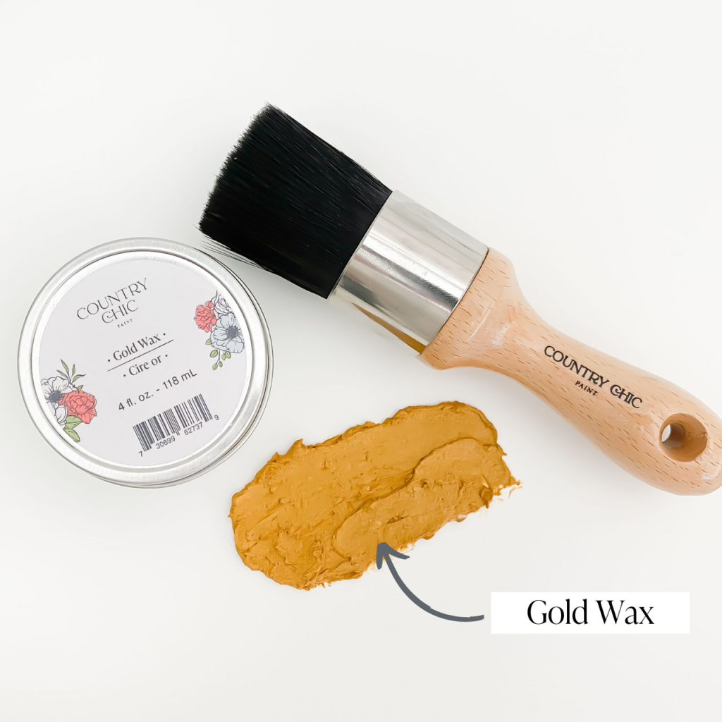 Flatlay of gold wax from country chic paint next to wax brush and smear of wax