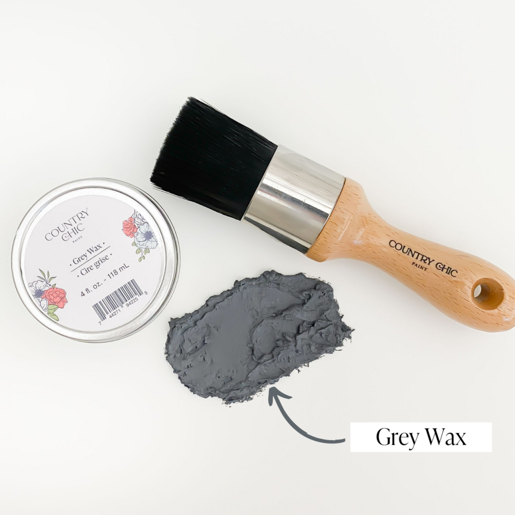 Flatlay of grey wax from country chic paint next to wax brush and smear of wax