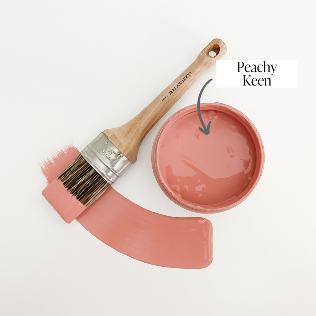 Top view of an open 16oz jar of Country Chic Chalk Style All-In-One Paint in the color Peachy Keen. Muted coral.