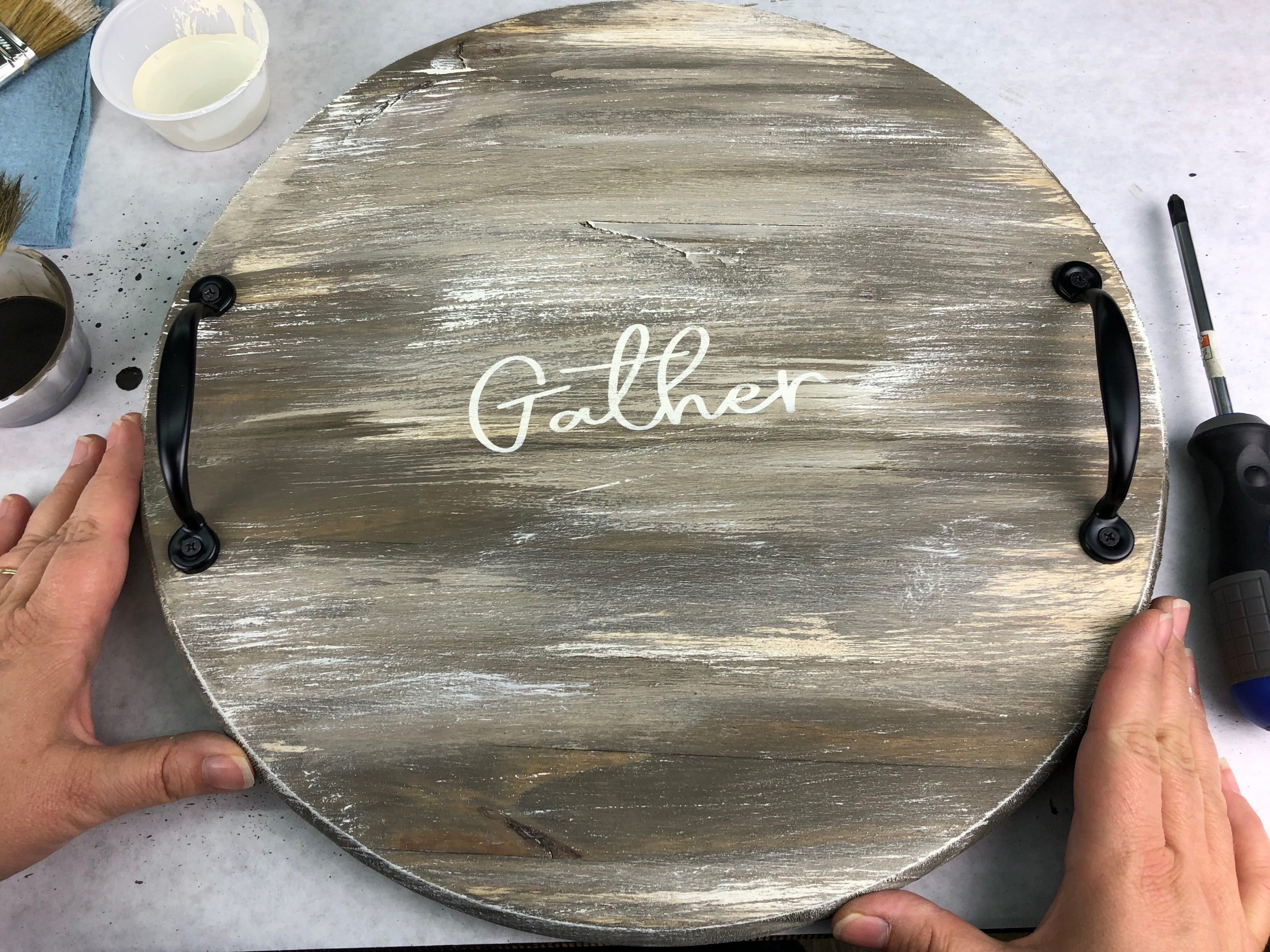 home made rustic round serving tray with handles and "gather" text
