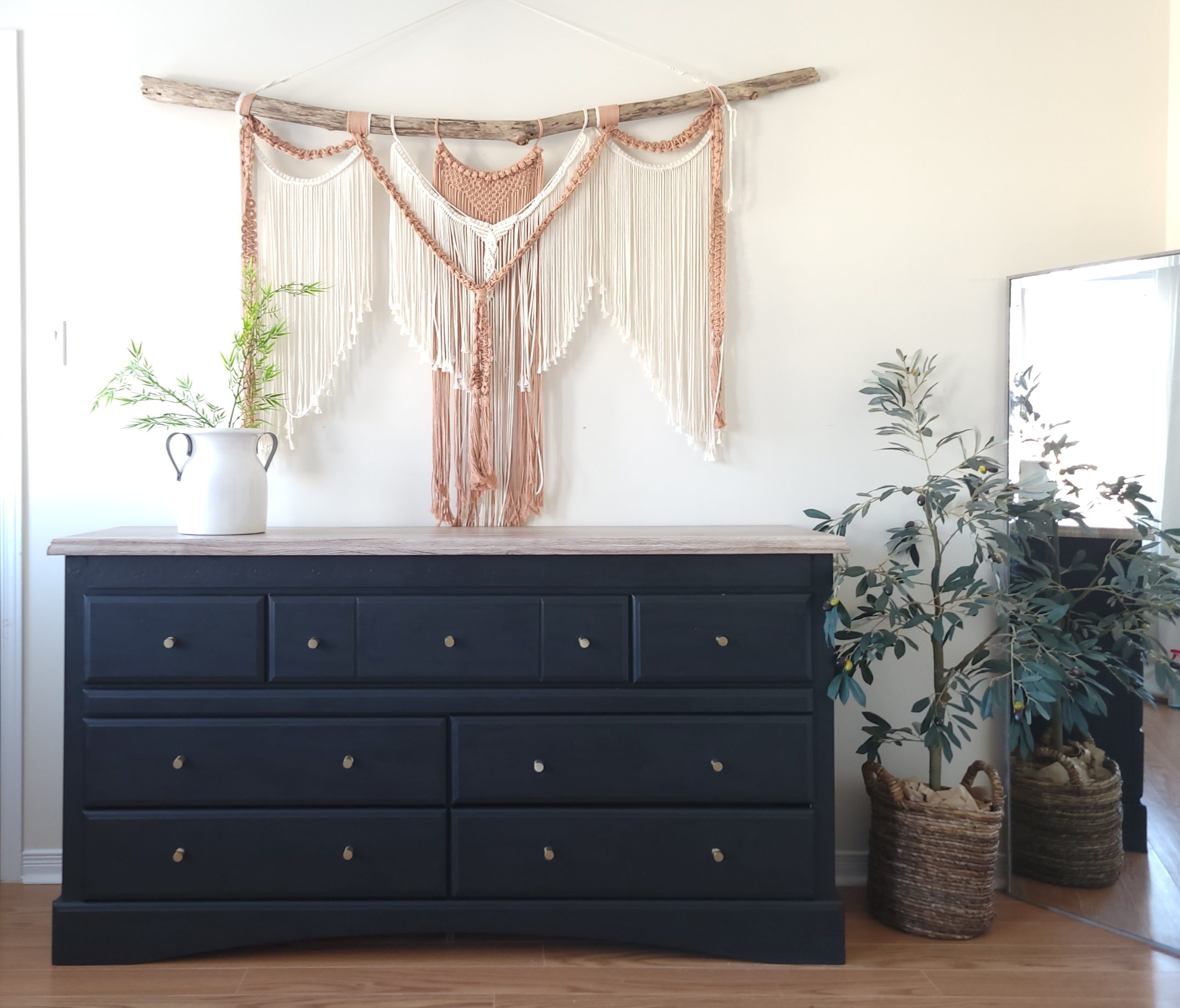 Black painted dresser with boho macrame wall hanging