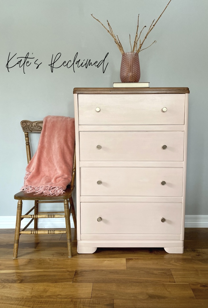blush pink dresser with minimalist gold knobs and antique wooden pressback chair