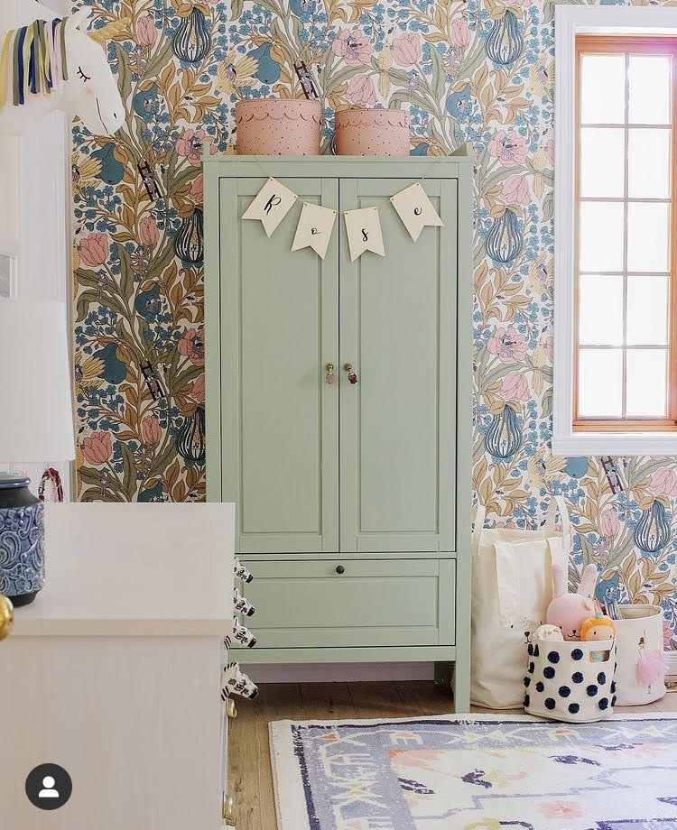 Sage green wardrobe with floral wallpaper and bunting - nursery furniture
