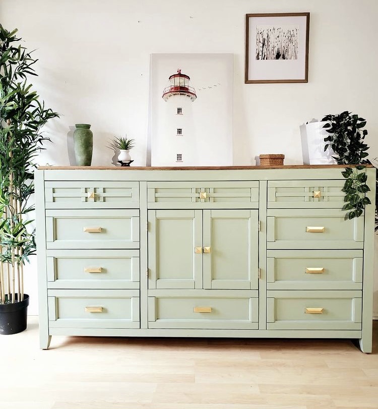 Sage green dresser with gold hardware square geometric pulls and lighthouse artwork